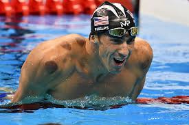 Michael Phelps in the swimming pool during the Olympics with cupping marks on his shoulders