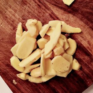 Fresh ginger, sheng jiang in pinyin, peeled and sliced to be used as a Chinese medicinal food